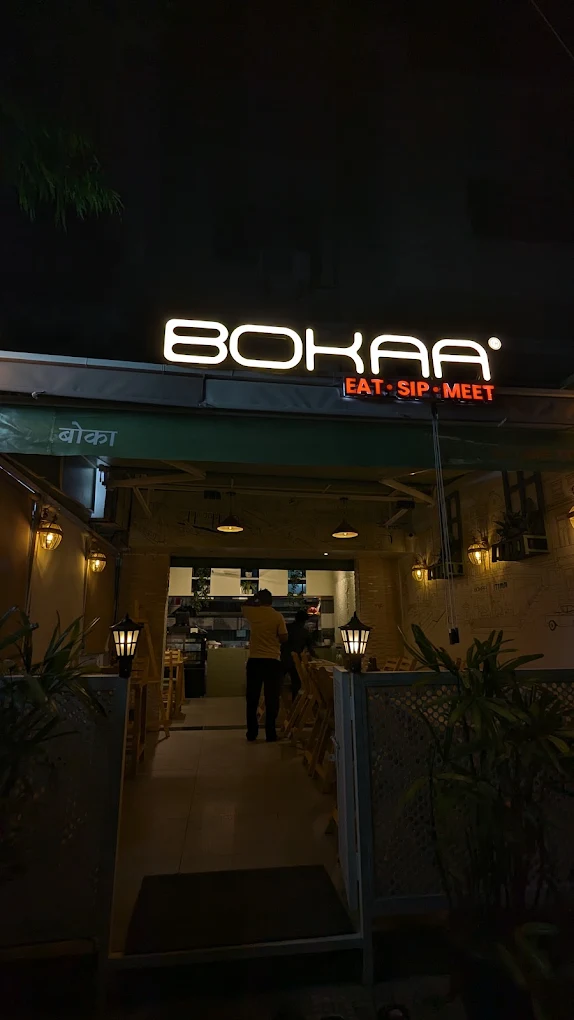 The Bokaa shopfront: a lit wordmark sign above a green awning